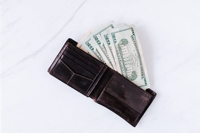 wallet with 20 USD bills in cash
